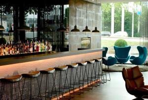 a living room filled with furniture and a fountain at Motel One Amsterdam in Amsterdam