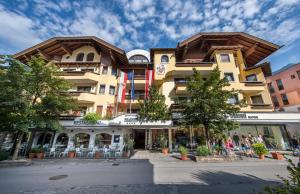 a building with people sitting outside of it at MANNI das Hotel in Mayrhofen