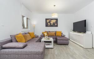 a living room with a couch and a flat screen tv at Villa Pendolina with Private Pool in Buje