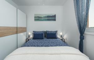 a bedroom with a blue bed with two blue pillows at Villa Pendolina with Private Pool in Buje +53 photos