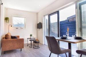 a living room with a dining room table and chairs at Vrijstaande vakantiewoning - Dicht bij het Strand in Zoutelande