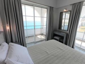 Ένα ή περισσότερα κρεβάτια σε δωμάτιο στο ALOS SUITES ex-Possirama Bay aparts