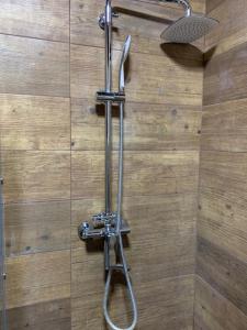 a shower with a hose attached to a wall at VIP Apartments 16 in Odesa +30 photos