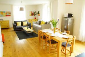 a kitchen and living room with a table and chairs at Apartmány u komína in Terezín