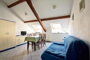 a room with a table and chairs and a kitchen at Hotel Primula in Alassio