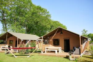 Opglabbeek的住宿－Glamping Belgisch Limburg，一个小房子,设有门廊和秋千