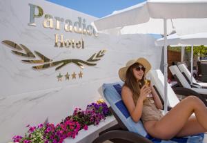 a woman sitting in a chair at a hotel at Paradice Hotel Luxury Suites-Near zorbas Beach-FREE Breakfast in Stavros