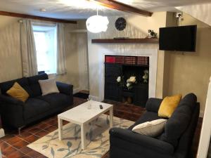 a living room with two couches and a fireplace at Main Street, Ballycastle, Co Mayo in Ballycastle