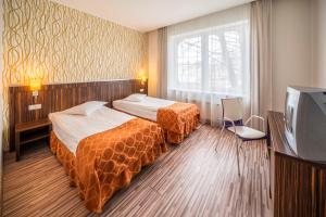 Postel nebo postele na pokoji v ubytování Rija VEF Hotel with FREE Parking