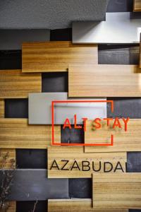 a sign that says allstay on a wooden wall at Ken's Place Azabudai in Tokyo