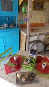 a doll house with food on a table at Caicai Bed And Breakfast in Saluzzo