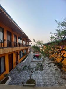 an empty courtyard of an apartment building with trees at Alley House Sapa Homestay in Sa Pa +51 photos