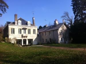a large white house with two chimneys on top of it at Room in Guest room - Maison lAmerique welcome you to one of their room Dogs are also welcomed in Saint-Jean-le-Blanc