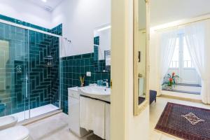 a bathroom with a sink and a shower with green tiles at Casetta Fuoro Guest House in Sorrento +32 photos