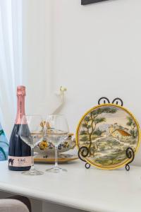 a table with two glasses and a bottle of wine at Casetta Fuoro Guest House in Sorrento