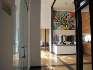 a hallway with a painting on the wall in a building at Open Hotel in Quillota