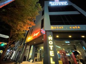 a hotel sign in front of a building at night at Victoria Station Hotel Melaka in Melaka