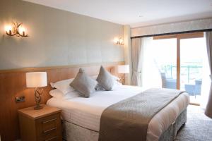 a hotel room with a large bed and a window at The Chase Golf & Country Club in Penkridge