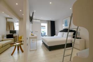 a bedroom with a bed and a living room at Piraeus City Hotel in Piraeus