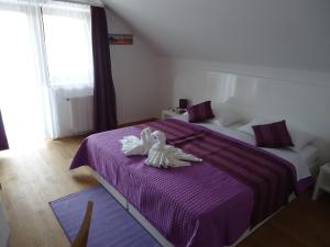 Posteľ alebo postele v izbe v ubytovaní Villa Rigo Panzió