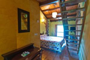 a room with a bed and a book shelf at Hotel Costa de Rodiles in Selorio