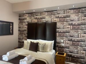 a bedroom with a wall made out of books at Arran Lodge B&B in Torquay