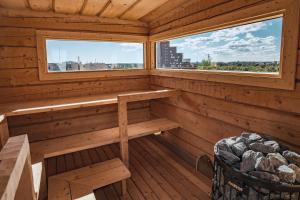 a sauna with a bench and two windows at VALO Hotel & Work Helsinki in Helsinki