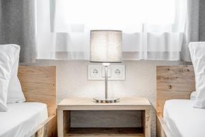 A bed or beds in a room at Gasthof Schroll