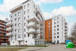 an apartment building next to two other buildings at Apartamenty Wyspa Solna by Renters in Kołobrzeg