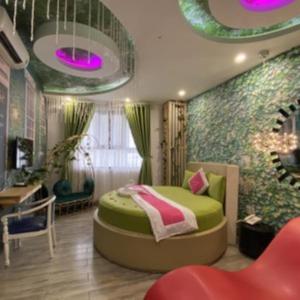 a bedroom with a green bed and purple lights at Tan Binh Hotel in Ho Chi Minh City