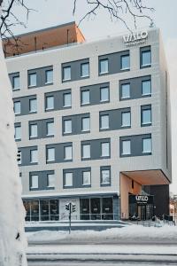 a building with a sign on the front of it at VALO Hotel & Work Helsinki in Helsinki