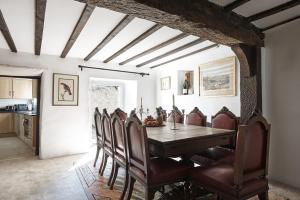 a kitchen and dining room with a table and chairs at Luxury Cotswolds Cottage optional Hot Tub, Castle Combe in Castle Combe