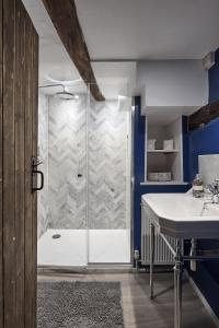 a bathroom with a shower and a sink at Luxury Cotswolds Cottage optional Hot Tub, Castle Combe in Castle Combe