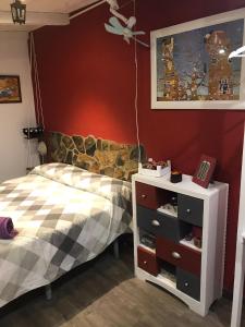 a bedroom with a bed and a dresser at Apartamento Árbol de vida - cerca Estadio Cartuja in Seville