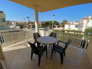 a table and chairs on a balcony with a view at Apartamentos Playa Del Moro III Altamar in Alcossebre