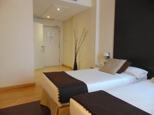 Postel nebo postele na pokoji v ubytování Hotel Ortuella