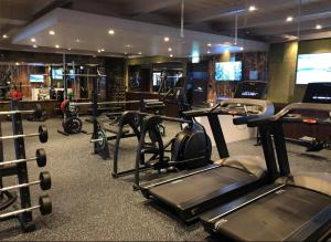 a gym with several treadmills and exercise bikes at Fanitullen Hotel in Hemsedal
