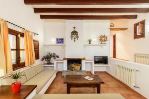 a living room with a couch and a fireplace at San Miguel Park in Sant Miquel de Balansat