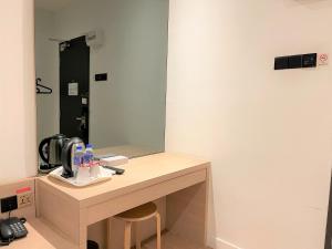a bathroom with a counter with a mirror at Victoria Station Hotel Melaka in Melaka