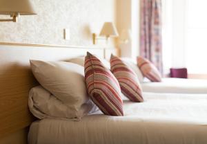 a hotel room with two beds with pillows at Bayshore Hotel in Sandown