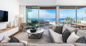 a living room with a couch and a table at Los Jardines de Abama Suites in Guía de Isora