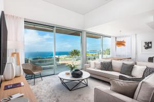 a living room with a view of the ocean at Los Jardines de Abama Suites in Guía de Isora
