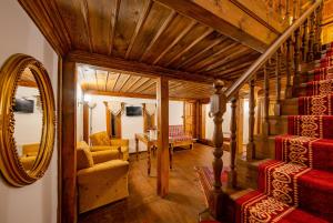 a living room with a staircase and a mirror at Hanedan Konak Hotel in Safranbolu