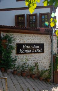 a sign on the side of a building with plants at Hanedan Konak Hotel in Safranbolu