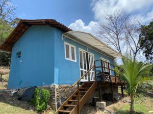 a blue tiny house with a porch at Casa do Ney in Fernando de Noronha