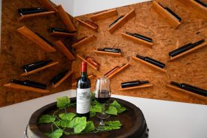 una bottiglia di vino e un bicchiere su un tavolo di Apartman Pejović a Kladovo