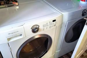a white washer and dryer sitting next to each other at Maison St-Raymond Duplex in Matane