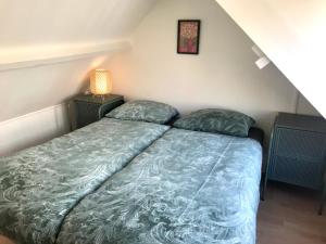 Ένα ή περισσότερα κρεβάτια σε δωμάτιο στο Ferienhaus Genießen am Meer mit Wellnesszugang