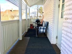 a porch with awning and a chair on a house at Apartment with garden and teracce in Oulu