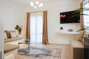 a living room with a couch and a table at The Z Private Villa, Santorini in Monolithos